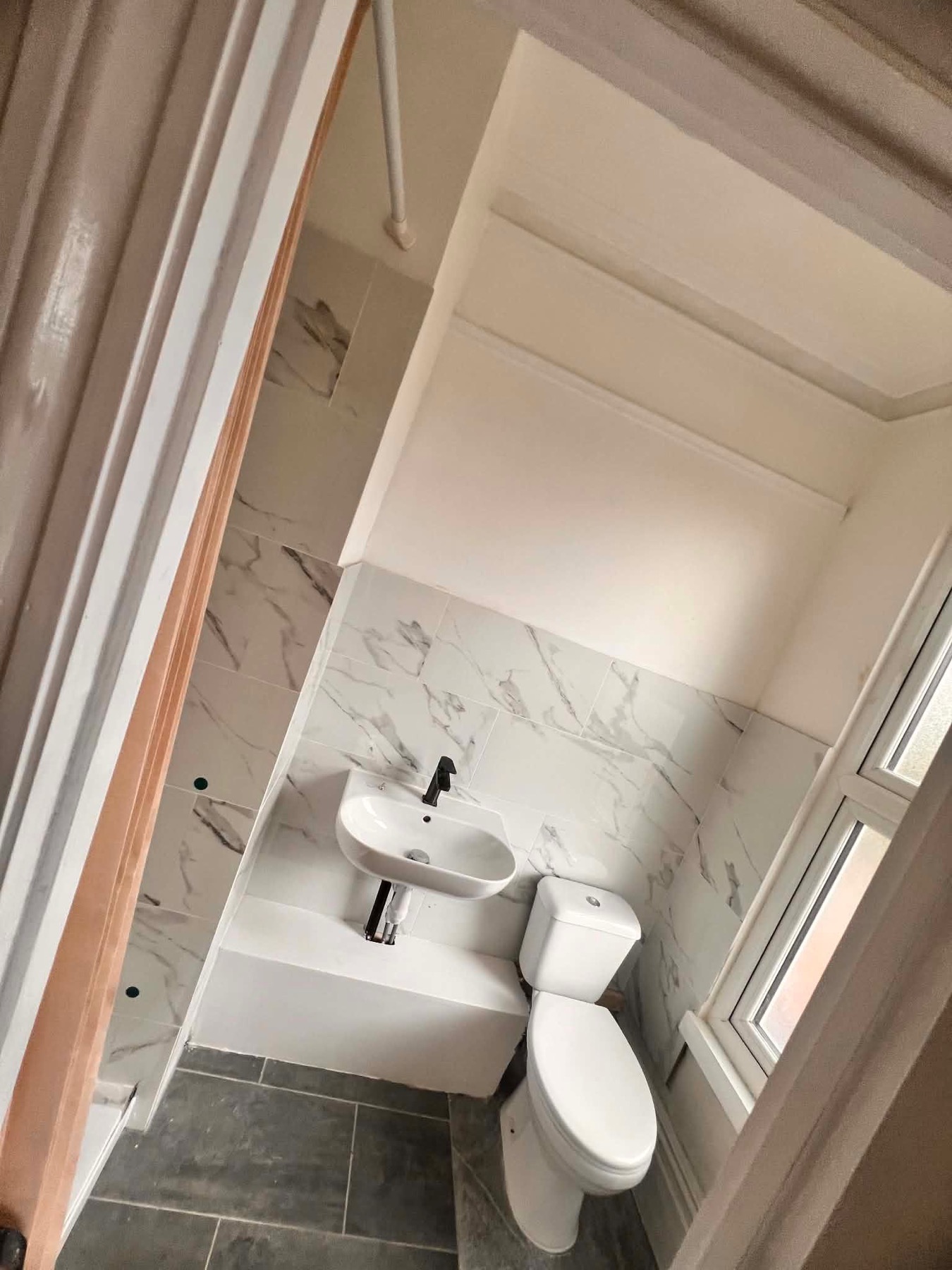 Bathroom with toilet, basin and shower area